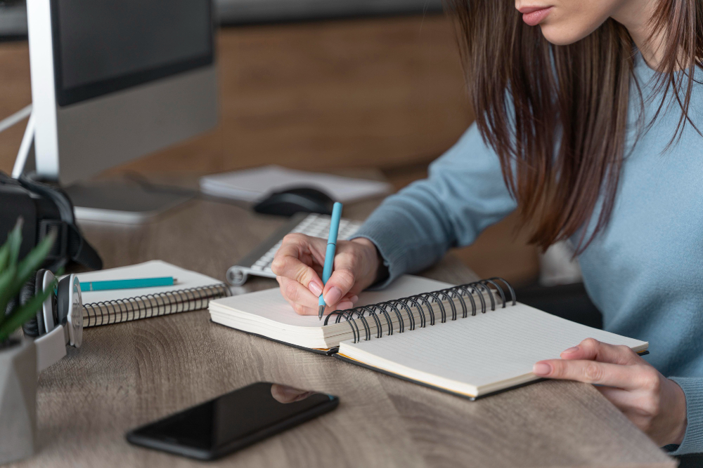 woman working media field writing stuff down notebook