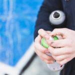 close-up-man-hand-holding-spray-bottle