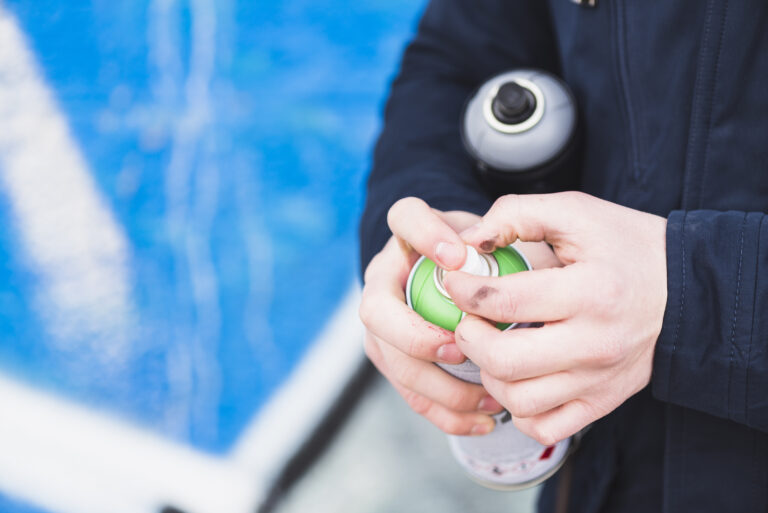 close-up-man-hand-holding-spray-bottle