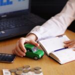 Closeup shot of a person thinking of buying a new car or selling a vehicle
